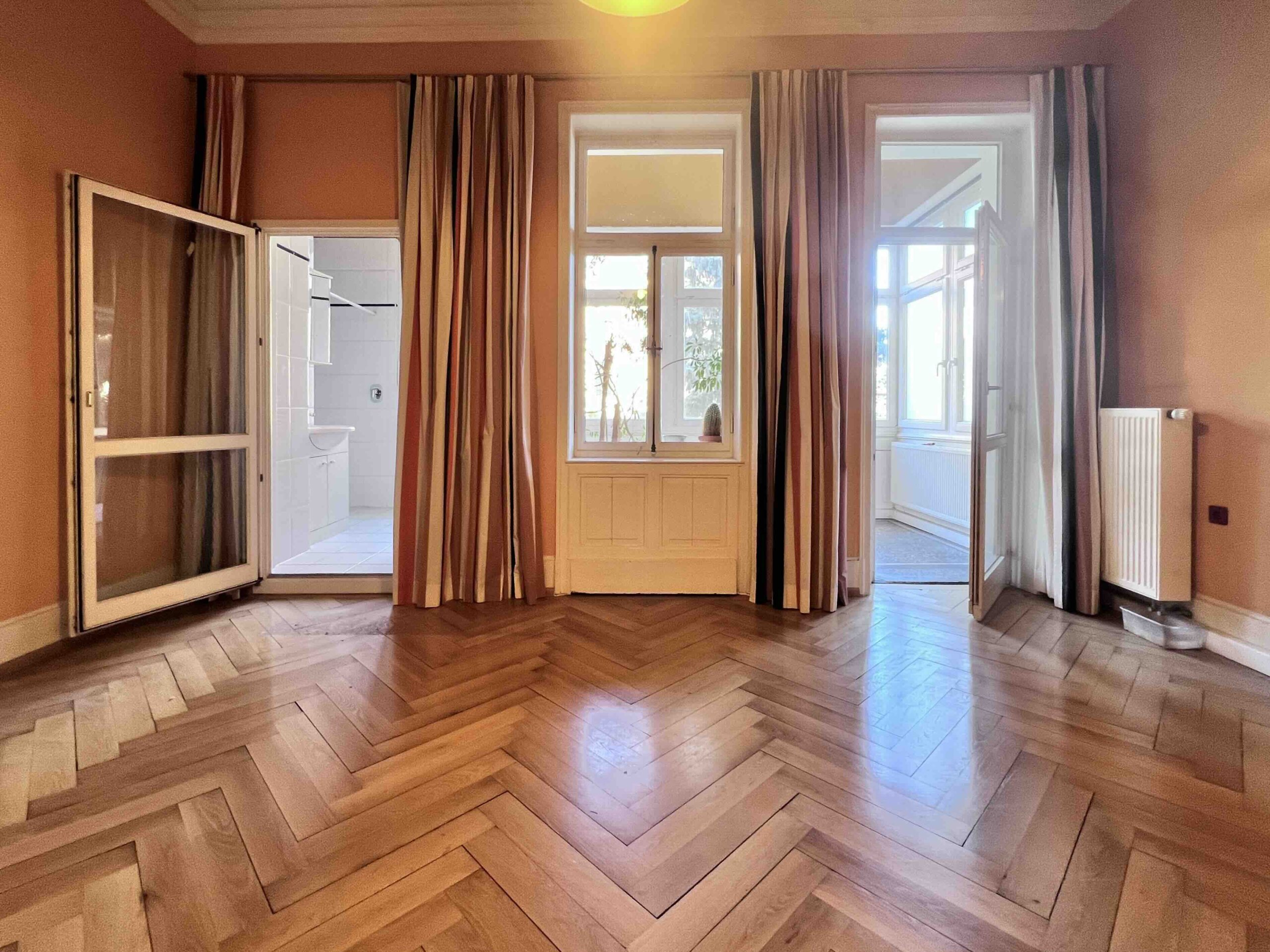 Orangefarbener Salon mit Zugang zum Badezimmer und zur Veranda